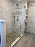 Full bathroom with stand up shower and tub on the lower level